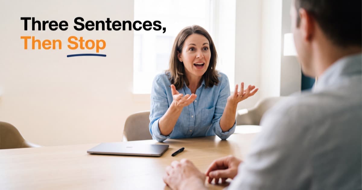 A person in a light blue shirt sits mid-sentence across a bright meeting room table from a colleague seen from behind, a closed laptop and a pen between them, beside the words Three Sentences, Then Stop