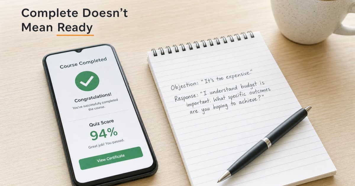 A smartphone on a bright desk showing a course-complete screen with a 94 percent quiz score, beside a notepad with one handwritten, untested objection response, coffee mug at the edge